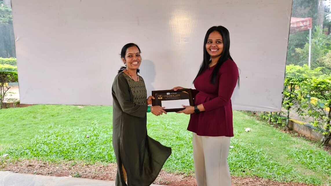 Nilofar Jargela giving Certificate to employee 2 of inevitable Infotech